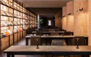 Modern library reading area with warm lighting and spacious tables.