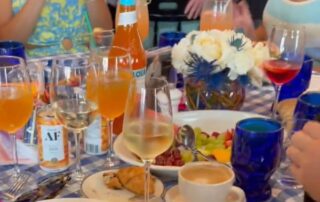 A table set with drinks, coffee, and snacks at a social gathering.
