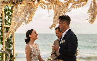 Beach wedding ceremony, bride and groom.