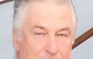 Close-up portrait of a man with light hair and blue eyes.