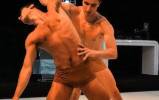 Two male dancers performing an expressive contemporary dance routine.