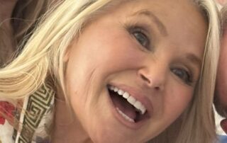 Smiling blonde woman in a close-up photo with joyful expression.