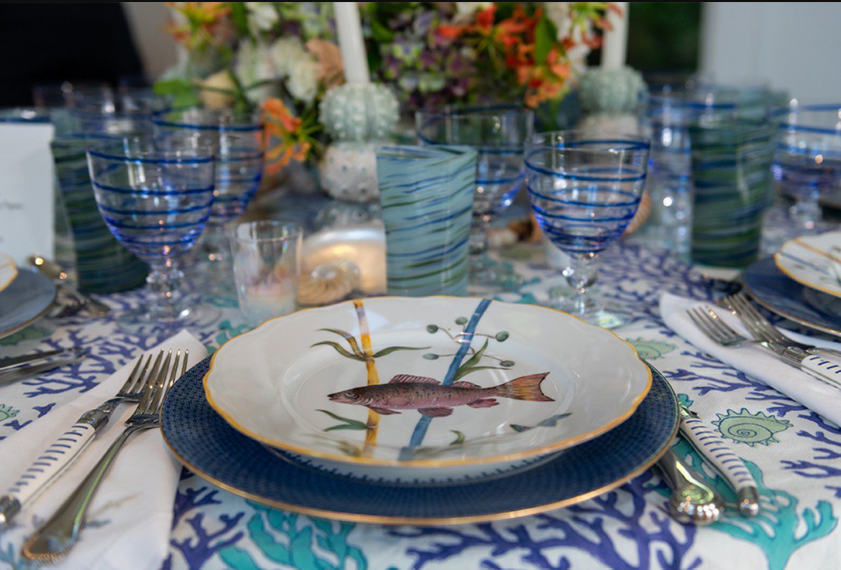A blue and white place setting with a fish.