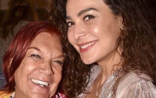 Two women smiling warmly together in a close-up photo.