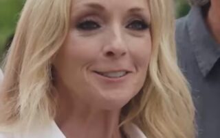 Blonde woman smiling, close-up.