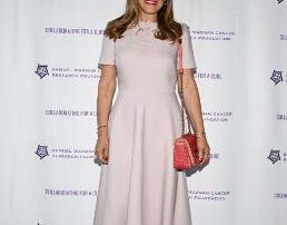 Woman in elegant light pink dress at a formal event.