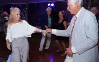 Couple dancing at an outdoor event.