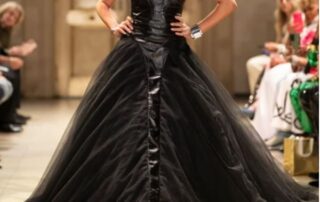 Black tulle and leather gown on runway.