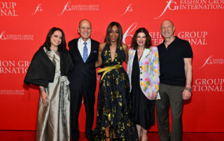 Five elegantly dressed individuals posing at a Fashion Group International event.