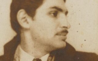 Vintage sepia photo of a man in a suit looking sideways.