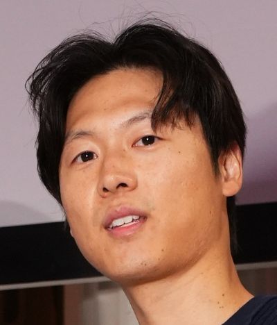 Close-up portrait of a young man with black hair.